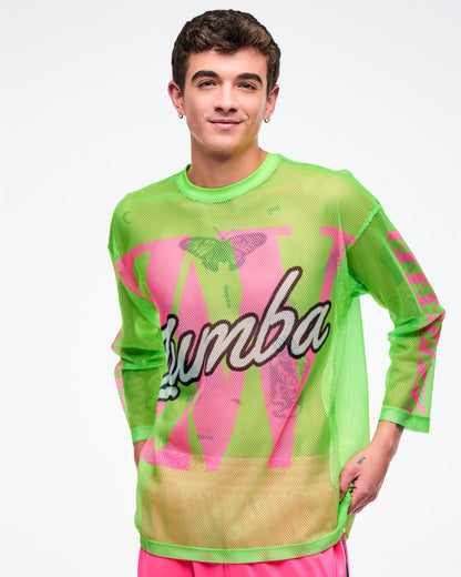 Male model wearing a neon green mesh long-sleeve Zumba top with bold pink graphics and white cursive “Zumba,” paired with pink pants.