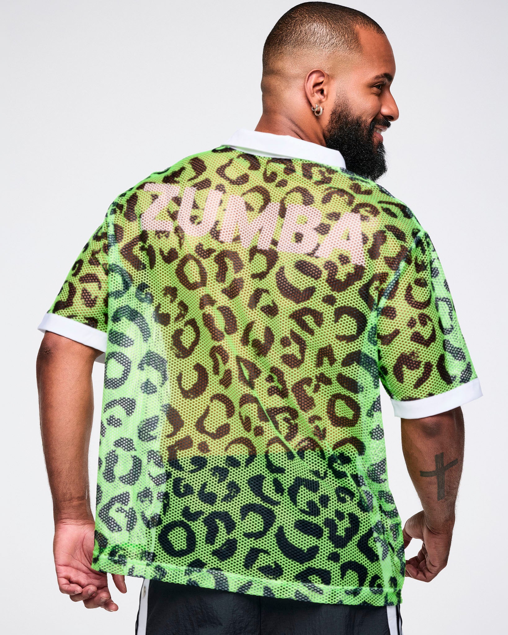 Back view of male model wearing a green leopard print mesh polo with white collar.
