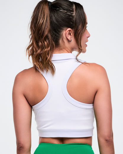 Back view of a female model wearing a white Zumba racerback polo.