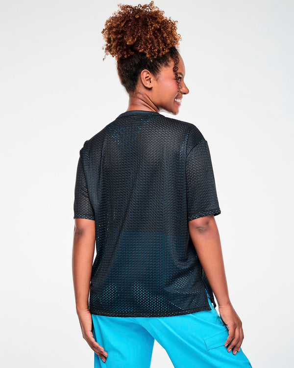 Shown from the back, a female model in the black Smurfs mesh top, with its plain back and a side slit at the hem.