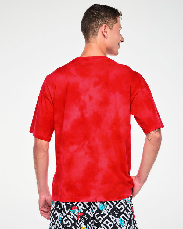 Shown from the back, a male model in the red and light cloud fabric wash Smurfs graphic tee, with a plain back and dropped shoulder seams.