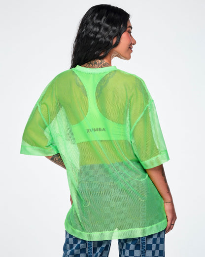 Back view of a female model wearing a green mesh Zumba top with a large black "ZUMBA 01" printed on the front, paired with blue checkered denim pants.
