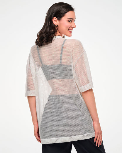 Back view of the white mesh oversized top, female model.