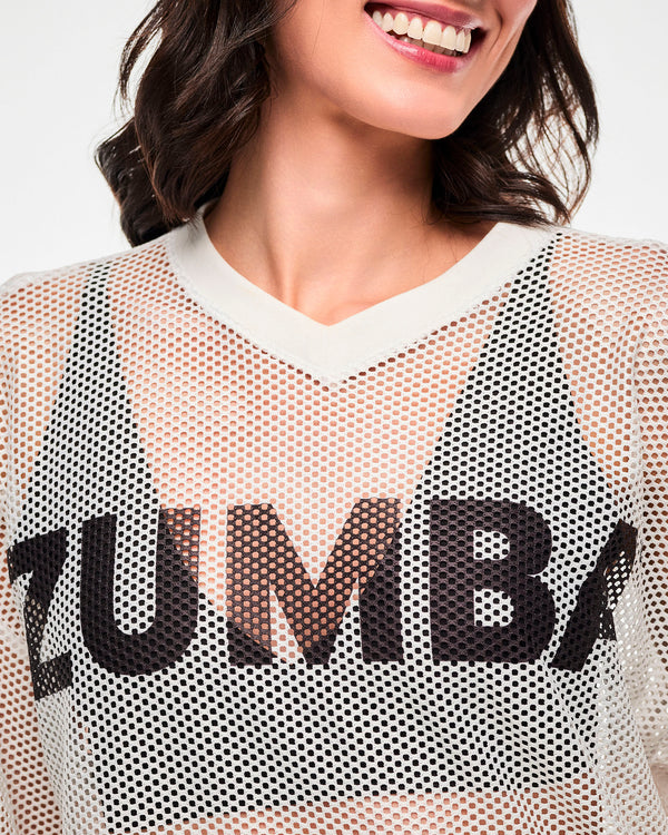 Close-up of the white mesh, the black 'ZUMBA' text near the V-neckline, female model.
