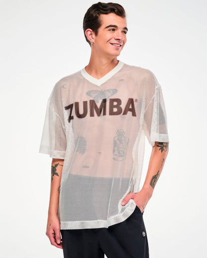 Male model in the white mesh oversized top with black 'ZUMBA' text, one hand in his pocket.