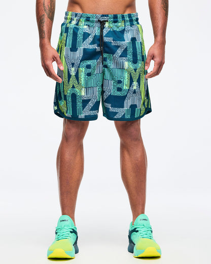 Teal-and-lime all-over print athletic shorts with an elastic drawstring waistband and curved side hem, shown from the front on a male model, paired with aqua-to-lime sneakers.