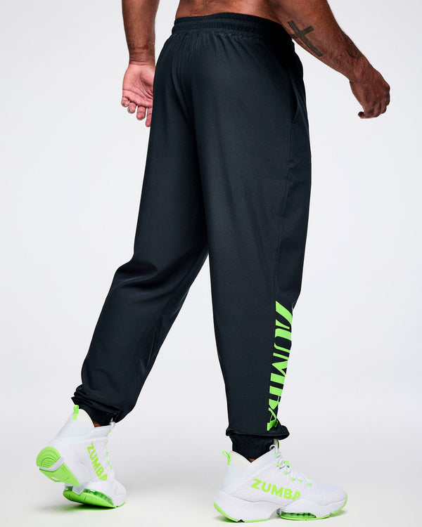 Back view of a male model wearing black cargo pants with green 