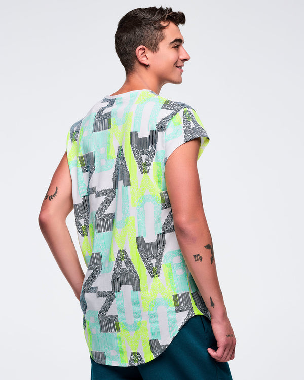 Back view of the longline all-over “ZUMBA” print cap-sleeve top on a male model, showing the curved hem and continuous graphic pattern, paired with teal jogger pants.