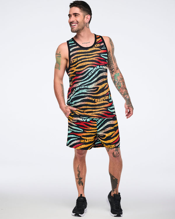 Male model wearing a sleeveless mesh tank in a black zebra-stripe print with multicolor brushstroke stripes in mint, yellow, orange, red, and beige, paired with matching shorts and black low-top sneakers with white soles.