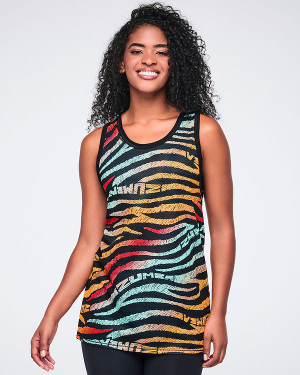 Female model wearing a sleeveless mesh tank in a black zebra-stripe print with multicolor brushstroke stripes in mint, yellow, orange, red, and beige, paired with black leggings.