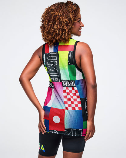 Female model from behind, wearing a colorful Zumba tank top on a white background.