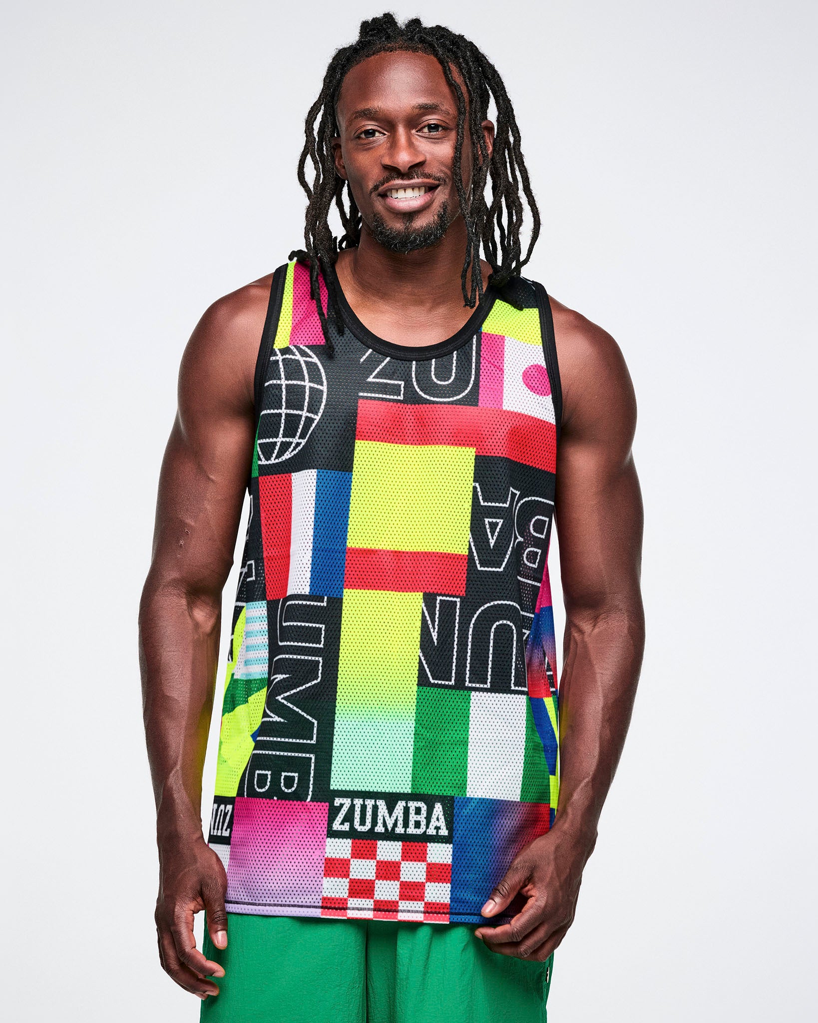 Male model wearing a colorful Zumba tank top against a white background.