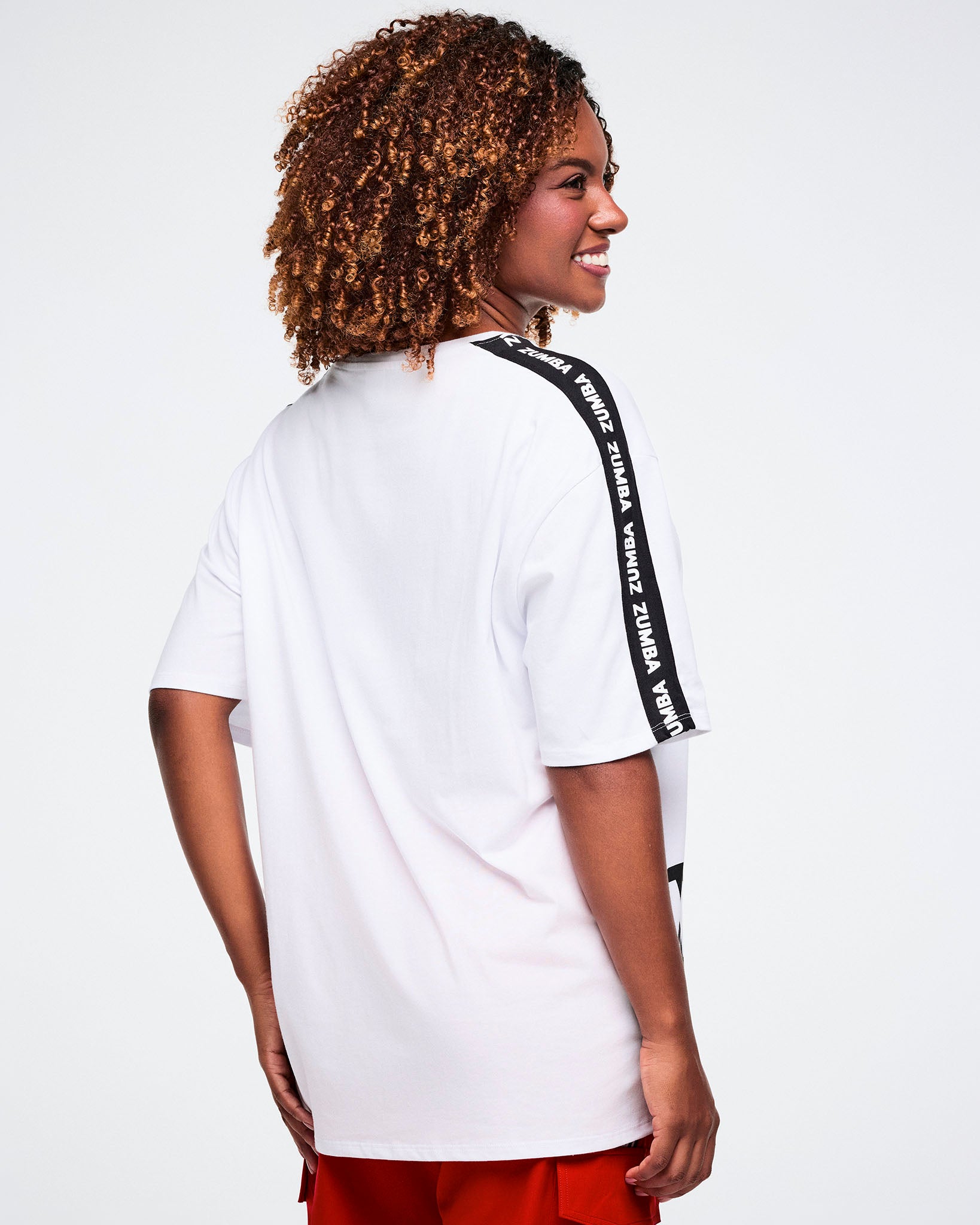 Female model, shown from the back, wearing a white t-shirt with black stripe details.