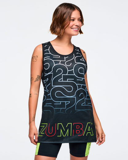 Black mesh tank with an allover silver 25 graphic and multicolor Zumba logo at the hem. A smiling female model wears the sleeveless longline tank over black bike shorts with neon green side panels against a light gray background.