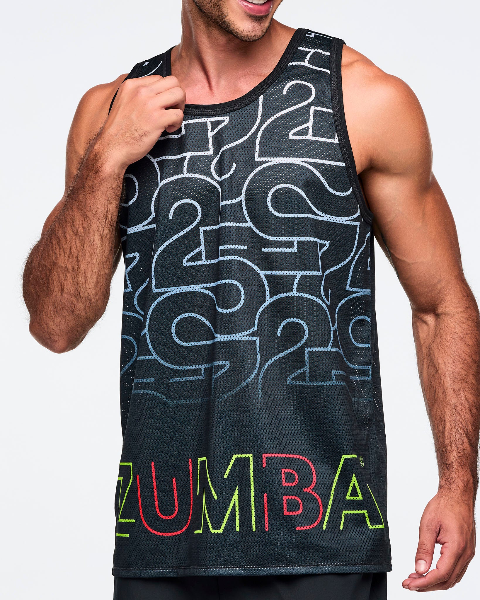Black mesh tank with an allover silver 25 graphic and multicolor Zumba logo at the hem, shown in a close-up view. A male model wears the sleeveless tank against a light gray background.