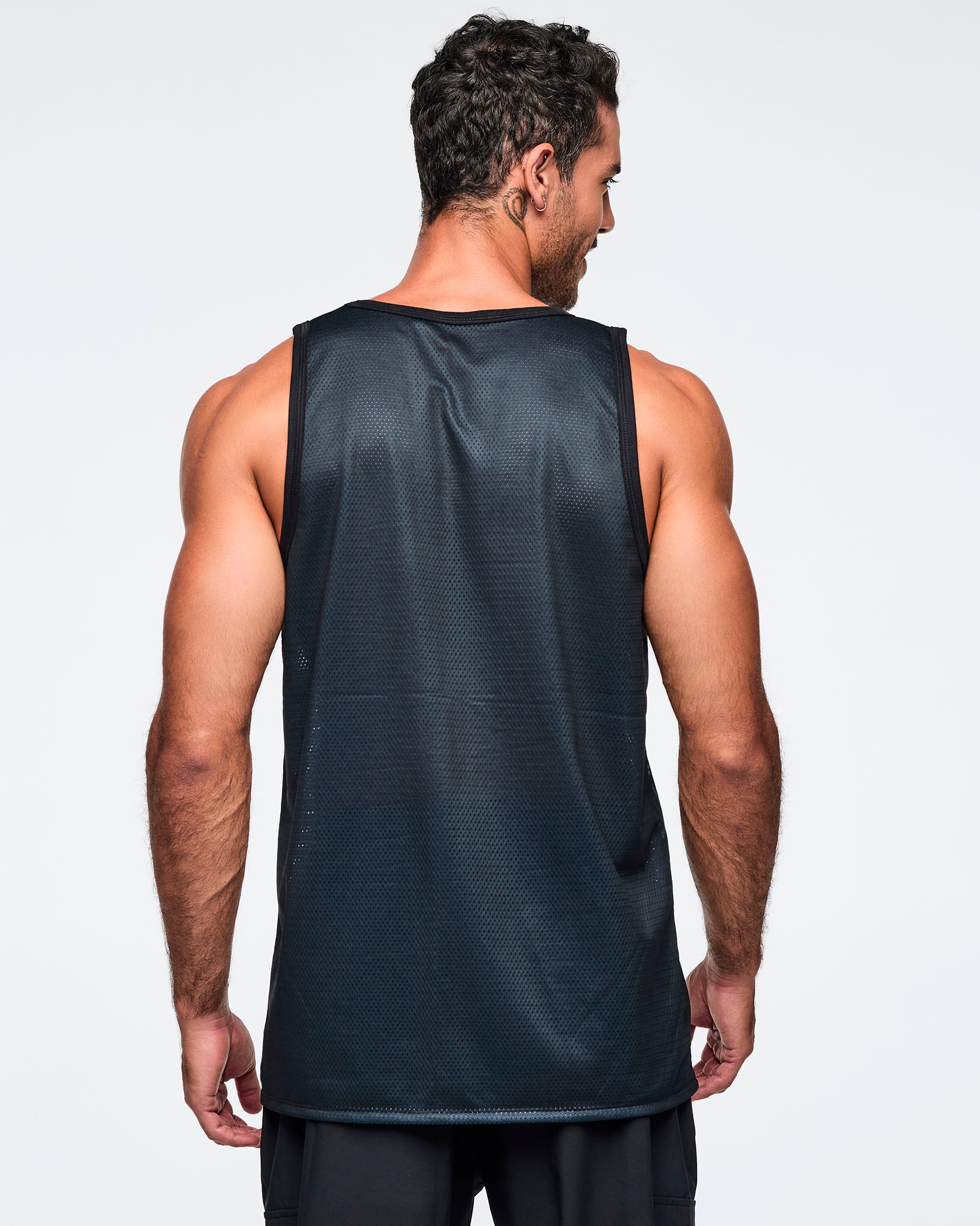 Black mesh sleeveless longline tank, shown from the back. A male model wears the tank with black pants against a light gray background.