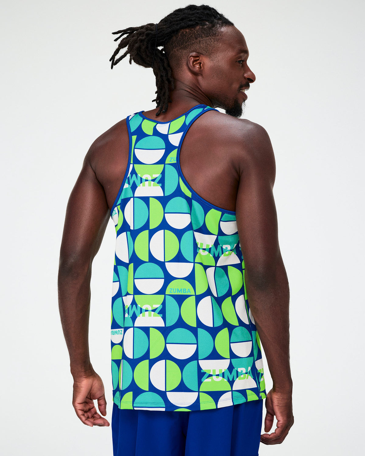 Shown from the back, a male model in the dark blue half-circle print tank, highlighting the racerback cut.