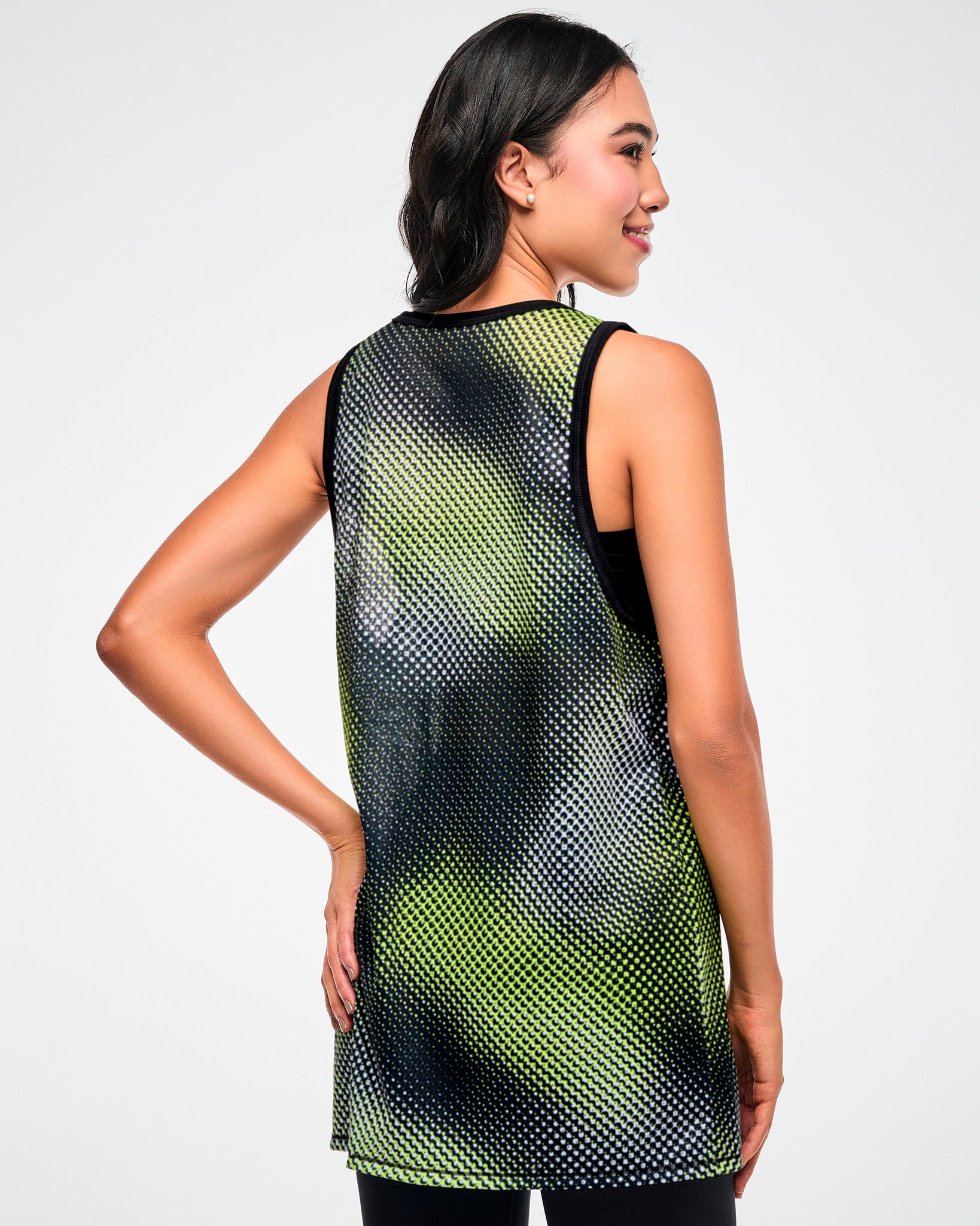 Shown from the back, female model wearing a black and yellow halftone dot-print tank top.