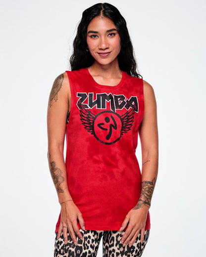 A female model wearing a red tank top with a distressed black and white Zumba text with a large black Zumbito graphic with wings, paired with tan leopard print leggings.
