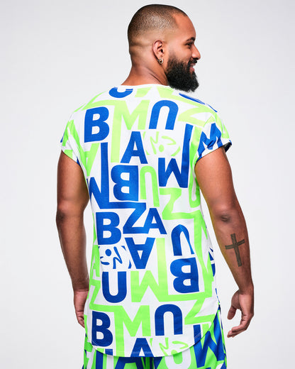 Back view of a male model wearing a colorful t-shirt with "ZUMBA" letter patterns on a plain background.