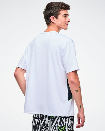 Back view of a male model wearing a white Zumba top on a plain background.