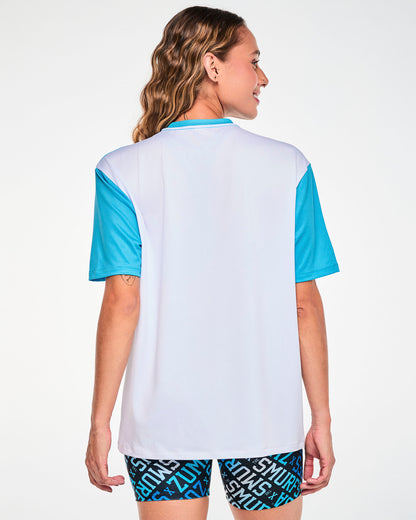 Shown from the back, a female model in the blue and white Smurfs mesh top, with its white back panel and blue sleeves.