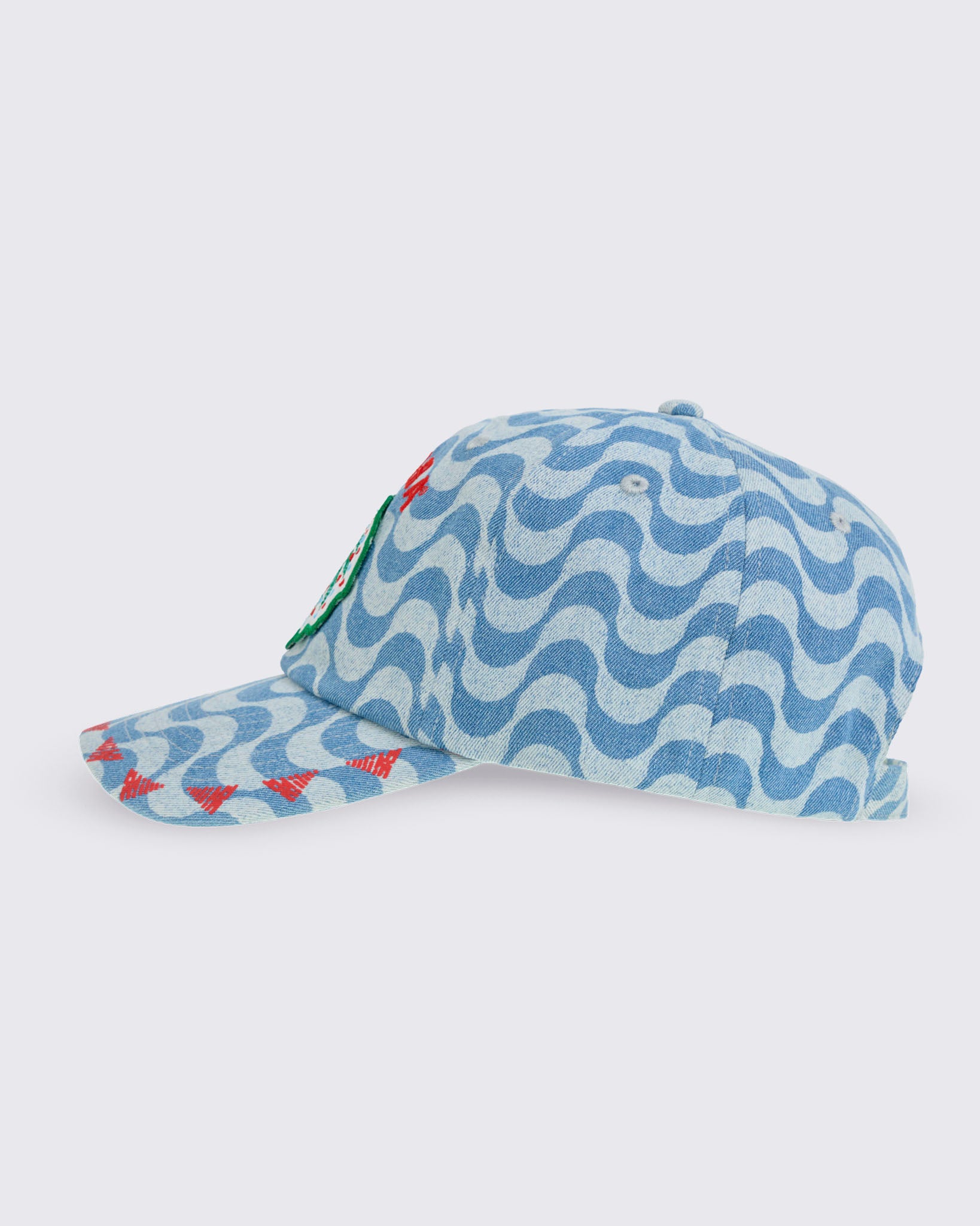 Light blue wavy-print baseball cap with curved brim and front palm-tree patch, shown in side view on a white background.