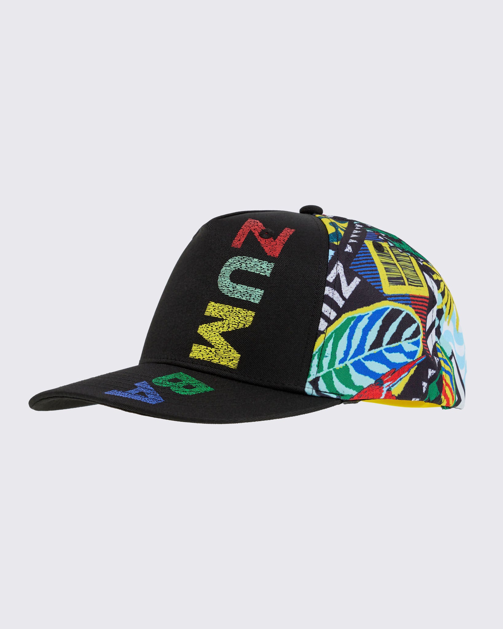 Product-only 3/4 front angle of the cap: black front panel with vertical multicolor “ZUMBA,” tropical-print side panels, flat brim.