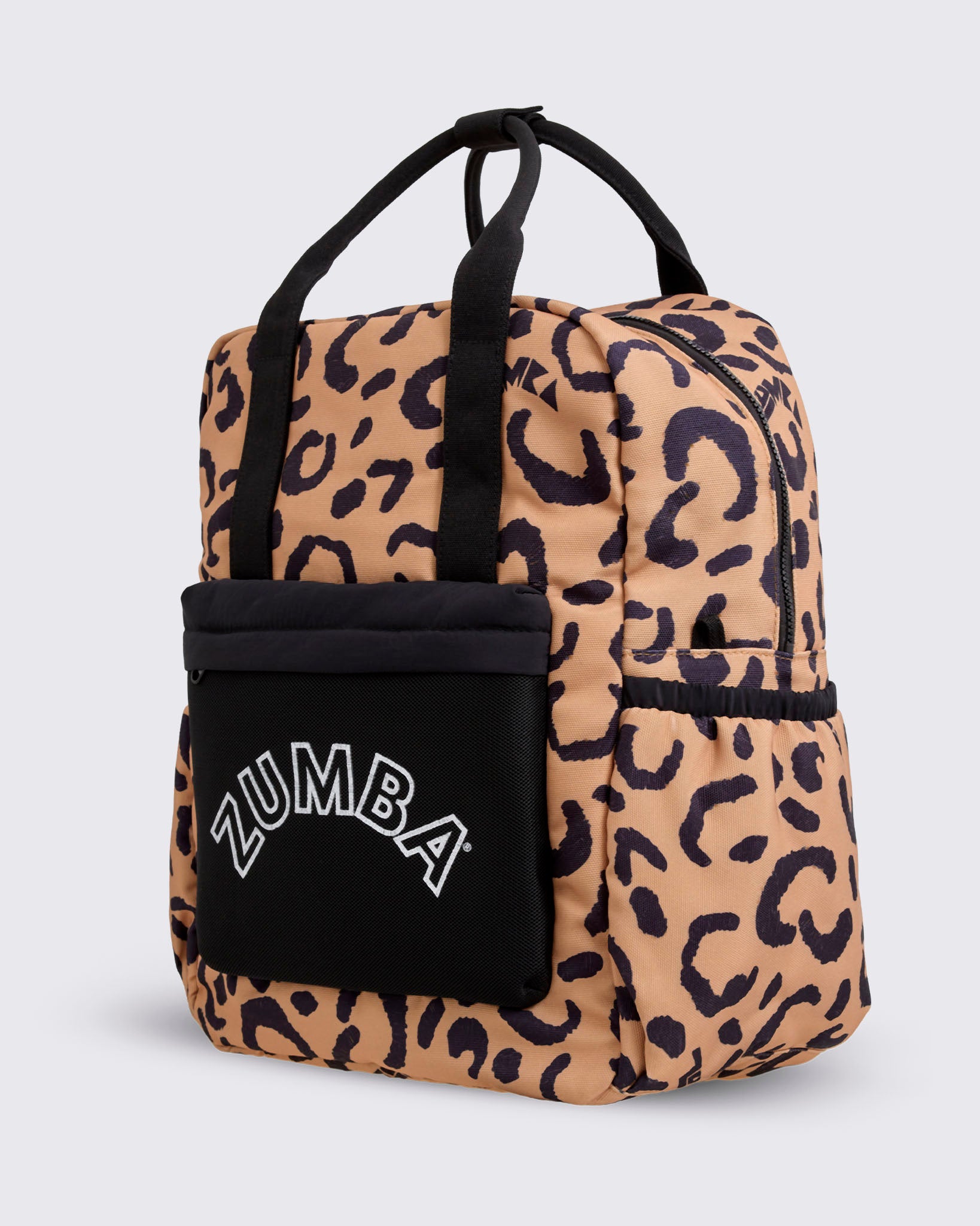 Leopard-print Zumba backpack shown at an angled front view with black top handles, a black front pouch with white ZUMBA logo, elastic side pockets, and a zip-around top closure against a light gray background.