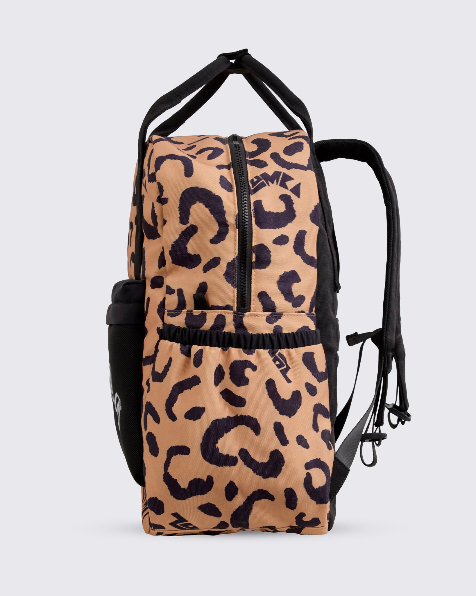 Side view of the leopard-print Zumba backpack with a zip-around top closure, elastic side pocket, black front pouch, black padded back panel, and adjustable shoulder straps visible.