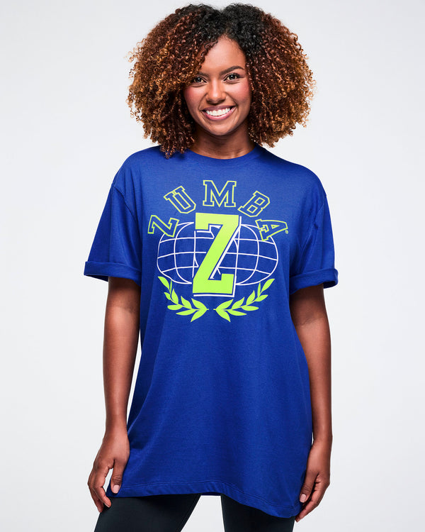 Female model wearing a blue t-shirt with a logo and Zumba text on a white background.