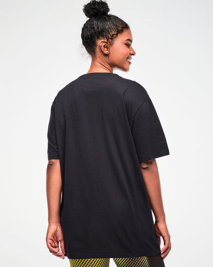 Shown from the back, female model wearing an oversized black T-shirt.