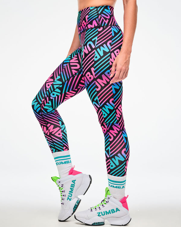 Female model wearing multicolor striped leggings with aqua-striped 