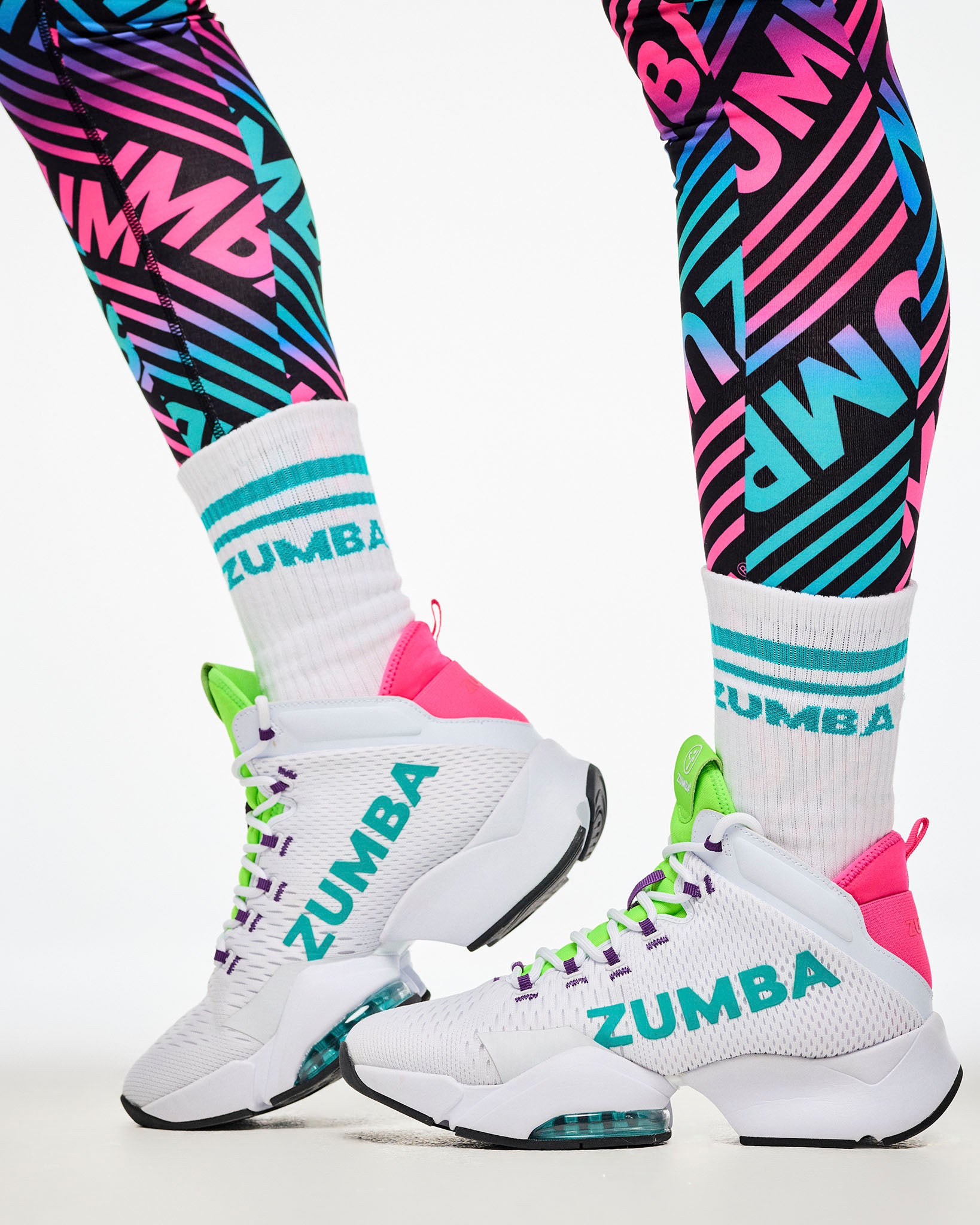 Close-up of colorful striped leggings, paired with aqua-striped socks and white and aqua shoes.