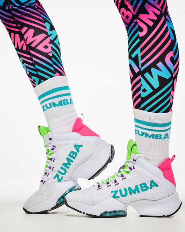 Close-up of colorful striped leggings, paired with aqua-striped socks and white and aqua shoes.
