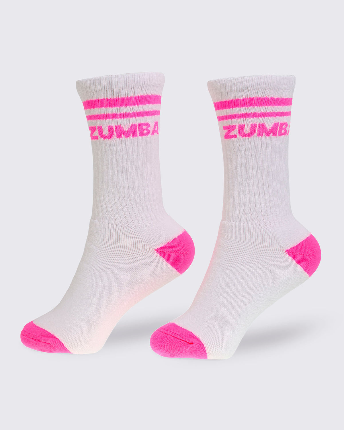 White crew socks featuring pink stripes, a pink heel and toe, and pink "ZUMBA" text.