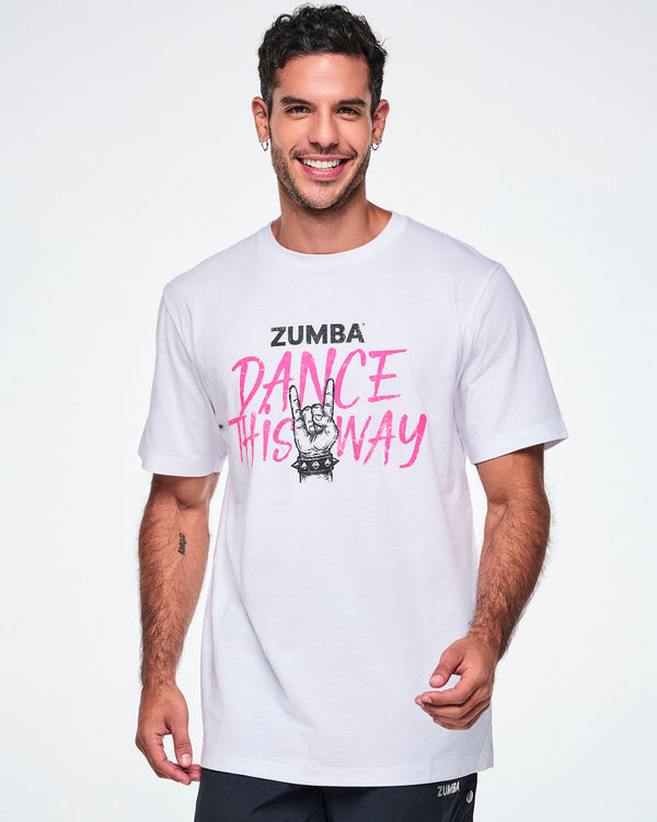 A male model wearing a white short-sleeve crewneck tee with a pink and black graphic that reads 'ZUMBA DANCE THIS WAY.' 