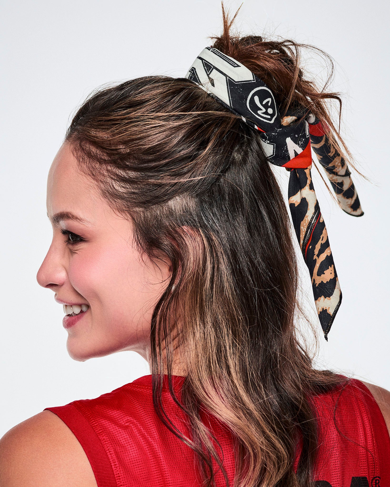 Close-up of a female model wearing a bandana as a hair tie.