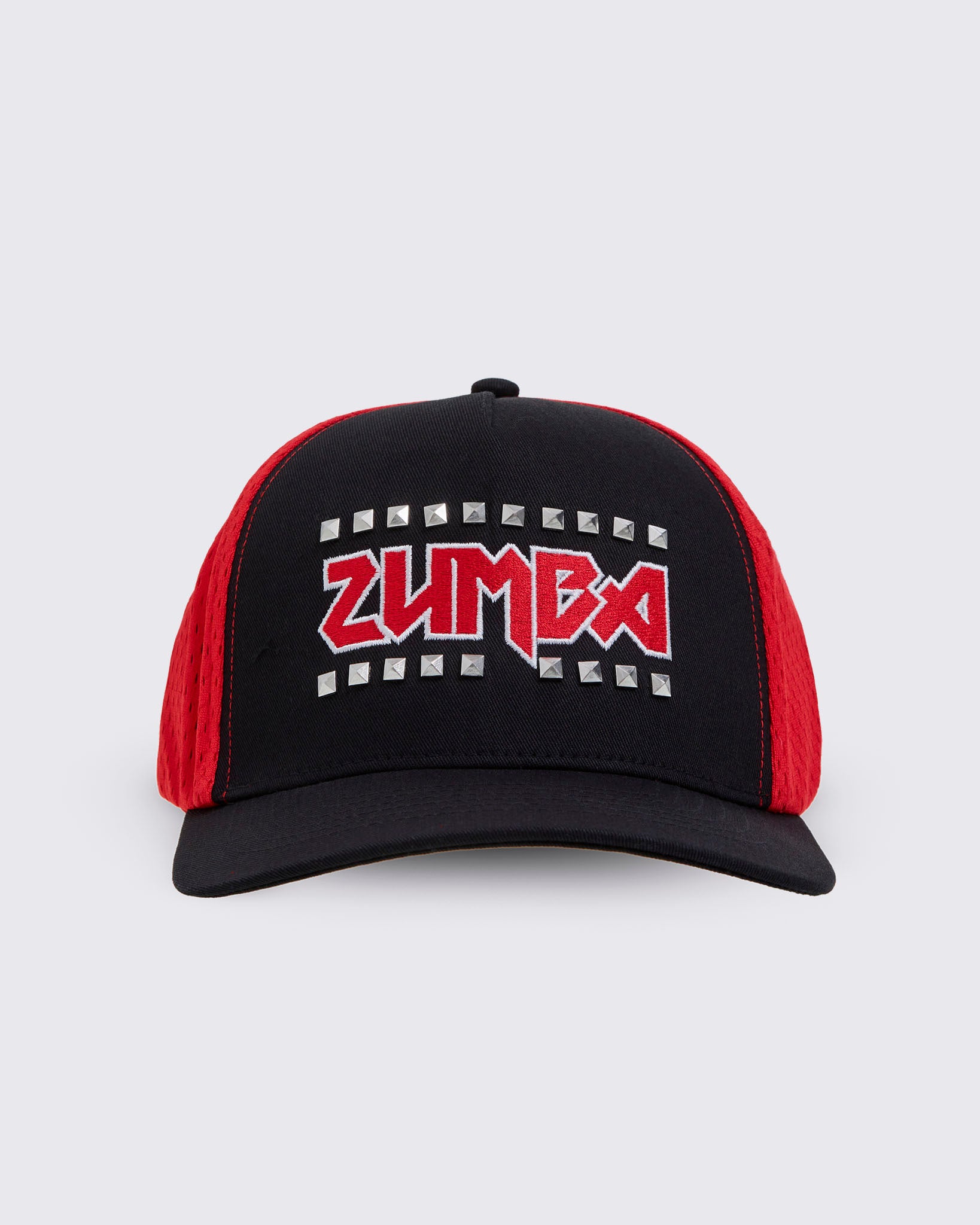 A black trucker-style hat with red mesh side panels and a red embroidered ZUMBA logo outlined in silver studs on the front.