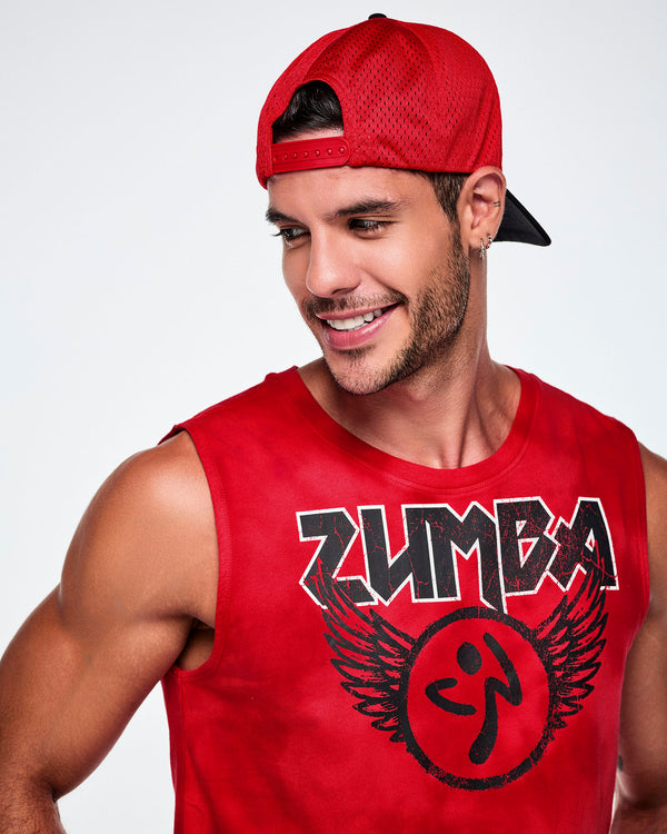 A male model wearing the a black and red hat backwards, showing the red mesh and paired with a red Zumba rock logo tank.
