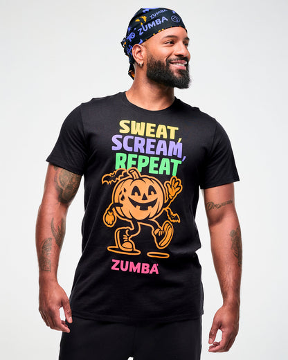 Male model wearing a black and purple Halloween bandana as a headwrap with a black "Sweat, Scream, Repeat" tee featuring a pumpkin graphic and "ZUMBA" in pink text.