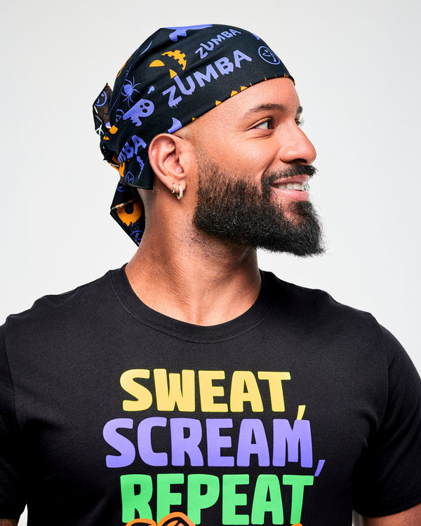 Male model wearing a black and purple Halloween-print bandana as a headwrap with a black 