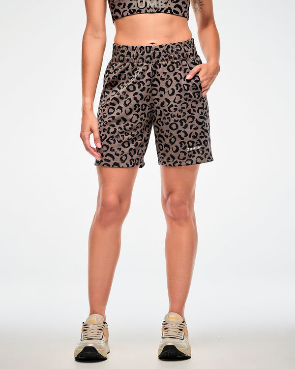 Female model in the brown leopard print easy shorts, showing the relaxed, above-the-knee fit, paired with a brown leopard print bra.