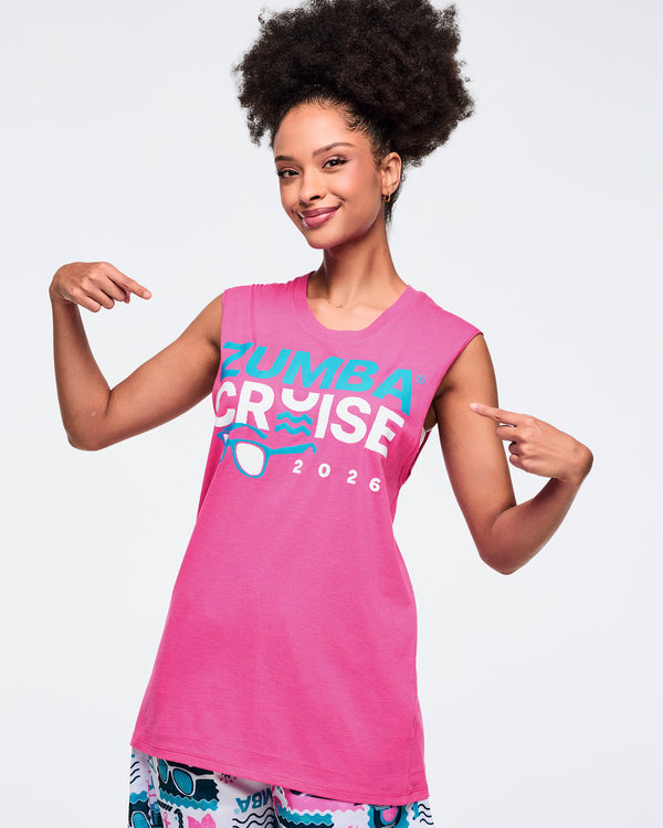 Female model wearing a pink Zumba Cruise 2026 tank top on a white background.