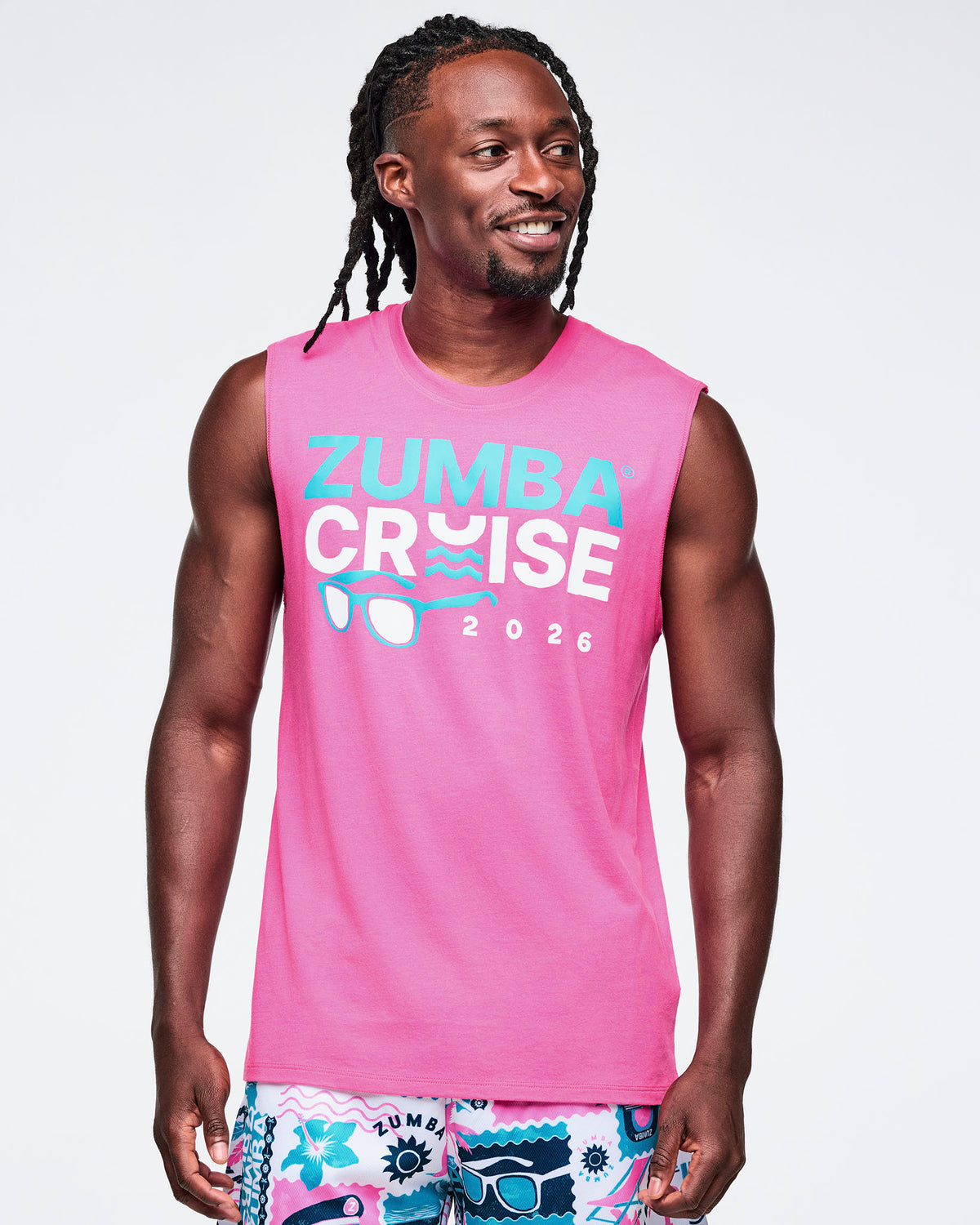 Male model wearing a pink Zumba Cruise 2026 tank top on a white background.
