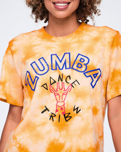 Close-up of an oversized orange and white tie-dye T-shirt with blue Zumba text, black “Dance Tribe” lettering, and a pink giraffe graphic on the front.