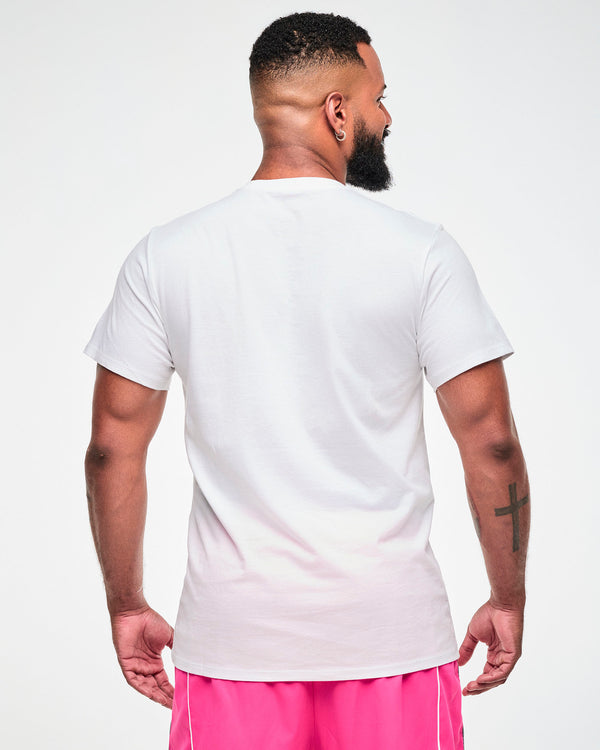 Shown from the back, male model wearing a white tee, paired with pink pants.