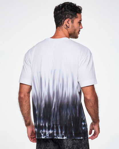 Back view of a male model wearing a white tee with a black-to-white tie-dye flame pattern at the bottom, posed against a white background.