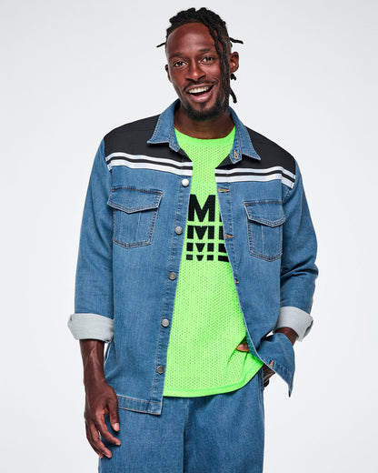 Front view of a male model wearing an open denim shacket with a black yoke featuring white stripes across the shoulders, layered over a neon green mesh tank top and pair with denim pants.